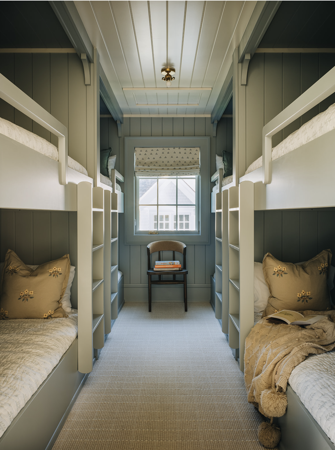 We are in the mood to pare down today, clear the clutter, and we have a feeling that, after seeing this perfectly tailored lake house from Jean Stoffer, you will be too! Kitchen with white clapboard and black and gold lanterns -Stoffer Photography Interiors dining room from Jean Stoffer design with water view - Stoffer Photography Interiors - Jean Stoffer Lake House - bunk room = bunk beds