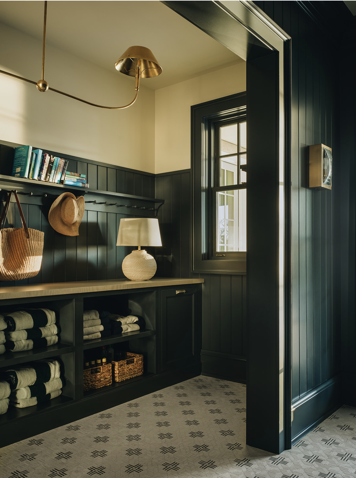 Stoffer Photography Interiors - Jean Stoffer Lake House - mudroom with dark paint and brass visual comfort chandelier