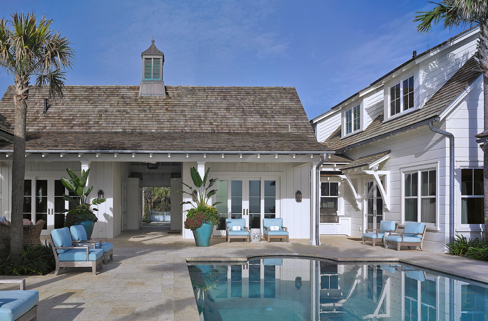 This stunning Ponte Vedra outdoor area with pool designed by the talented Collins Interiors is elegant, fresh and fun--everything a beach house should be! Nathan Schroder Photography -
