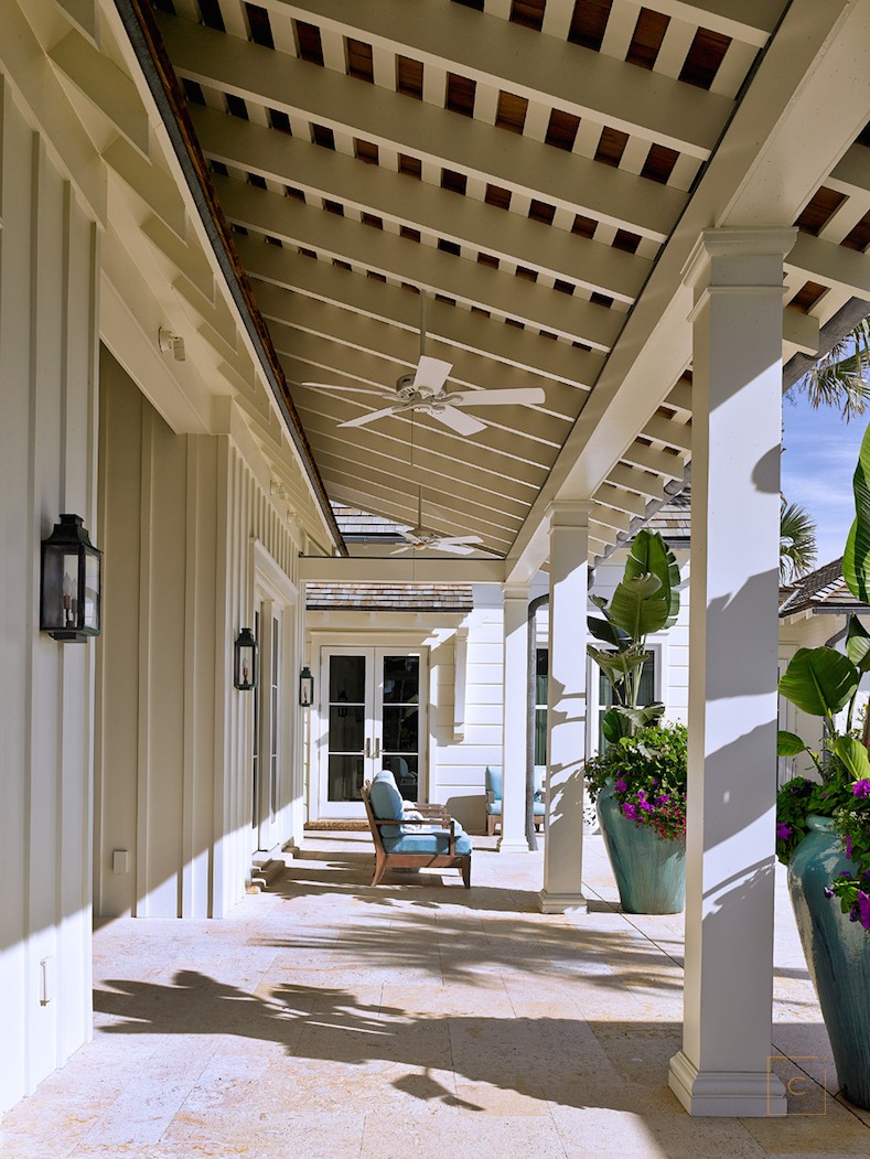 This home with covered porch by the talented Collins Interiors is elegant, fresh and fun--everything a beach house should be! Nathan Schroder Photography