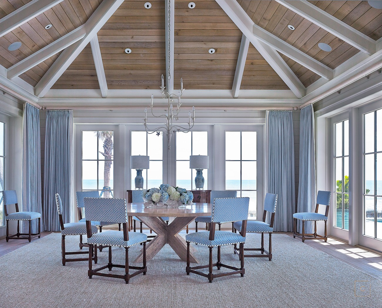 This stunning Ponte Vedra home design by the talented Collins Interiors is elegant, fresh and fun--everything a beach house should be! Nathan Schroder Photography - coastal dining room with wood stained ceiling with white beams