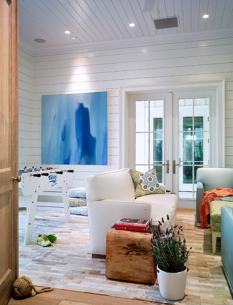 This stunning Ponte Vedra home design by the talented Collins Interiors is elegant, fresh and fun--everything a beach house should be! Nathan Schroder Photography - game room with foosball table and white shiplap walls
