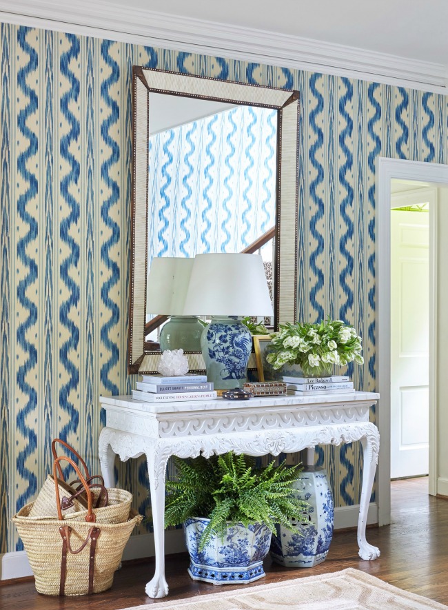 flowers on entry table by Sarah Bartholomew with quadrille wallpaper