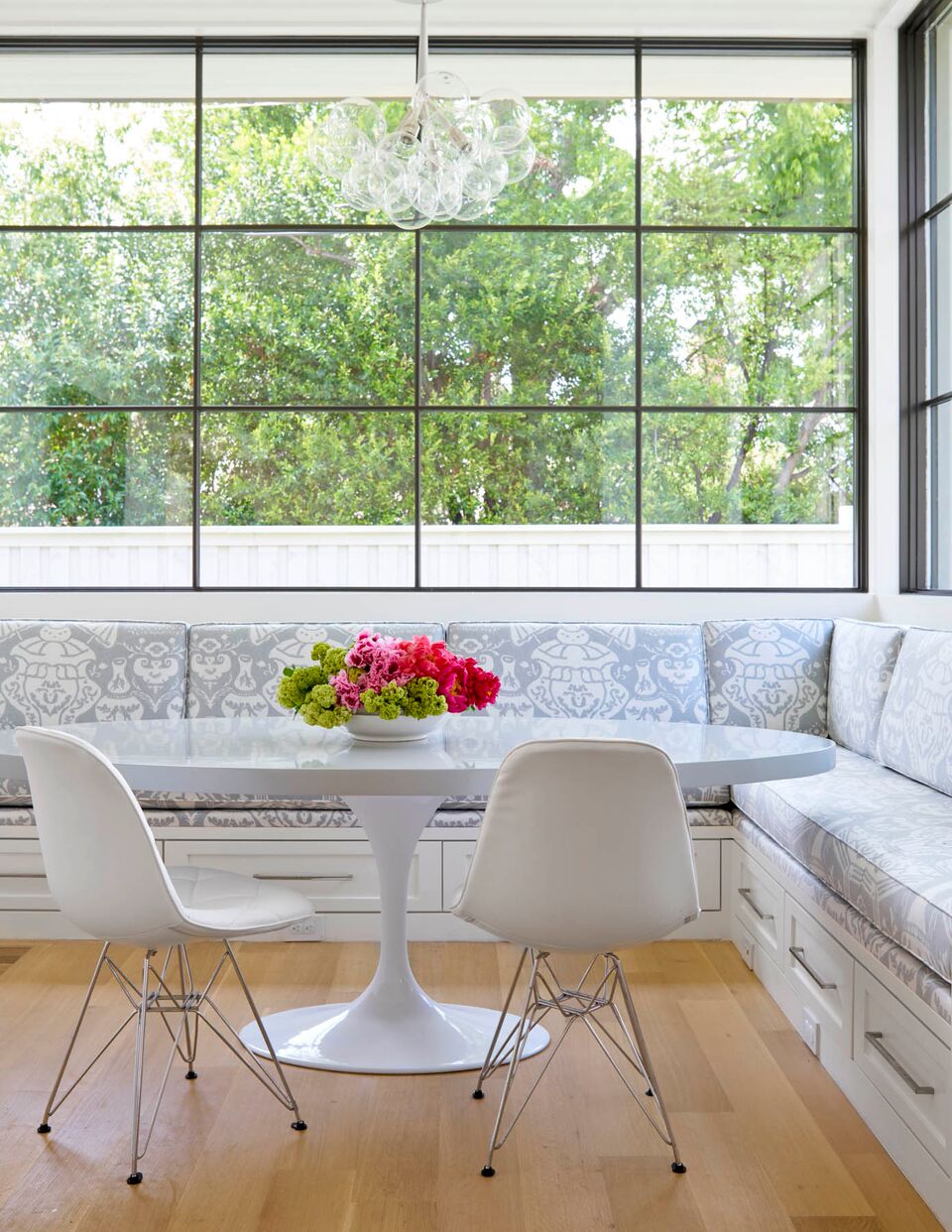 Collins Interiors | Nathan Schroder Photography - built-in banquette with oval saarinen table
