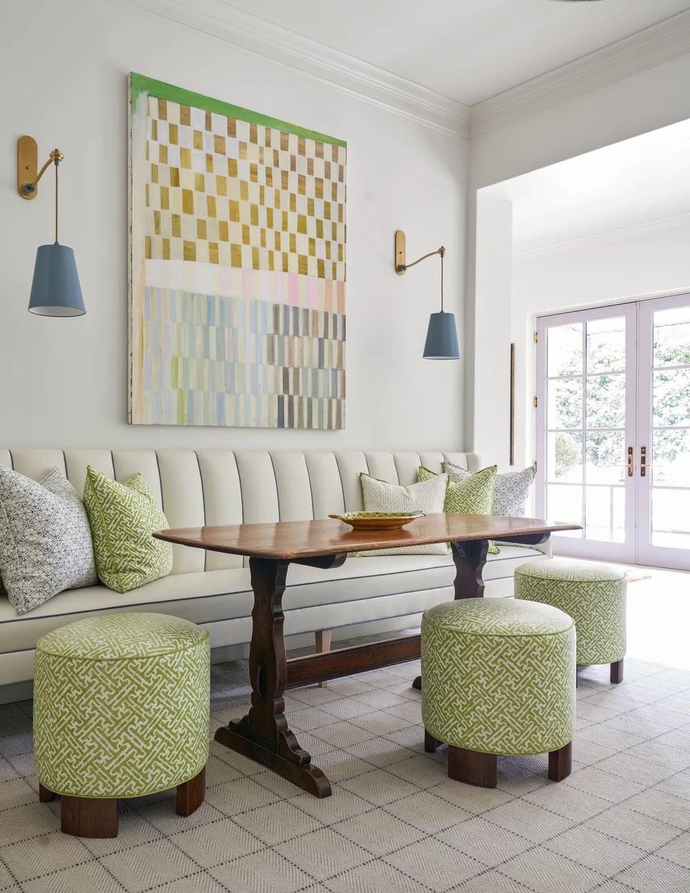 Jenkins Interiors | Nathan Schroder Photography - white banquette tufted  with green stools in this charming breakfast room