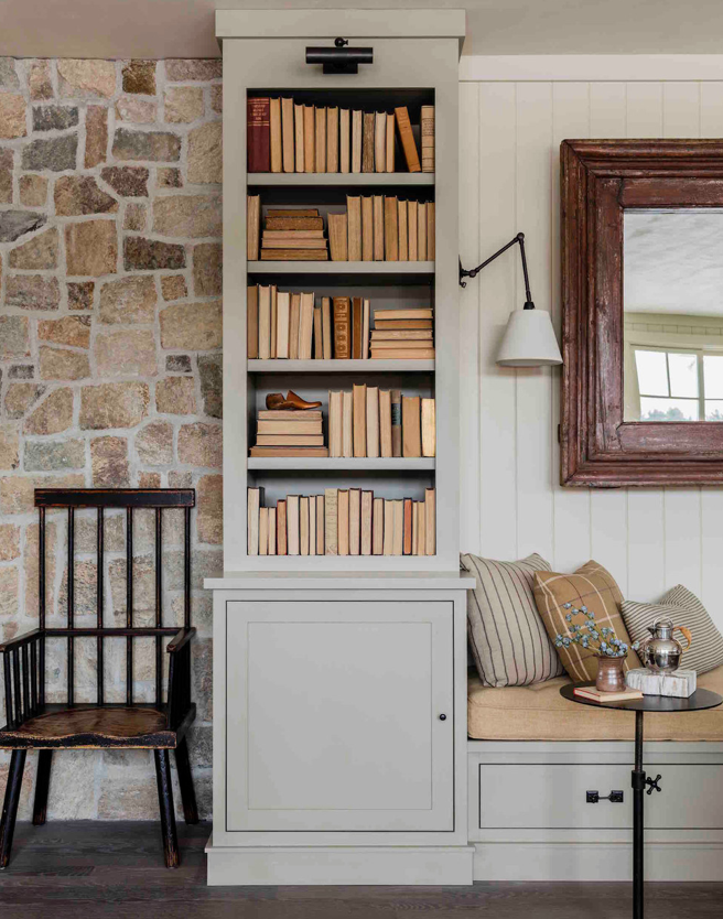 living room with stone wall and bookcase