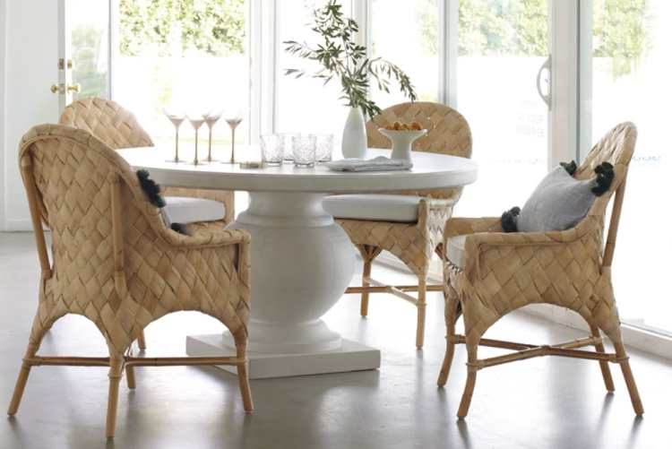 coastal breakfast room from Serena & Lily with wicker chairs and a round dining table