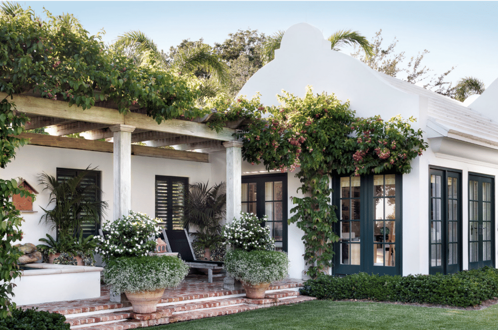 house and garden with climbing vines and pergola