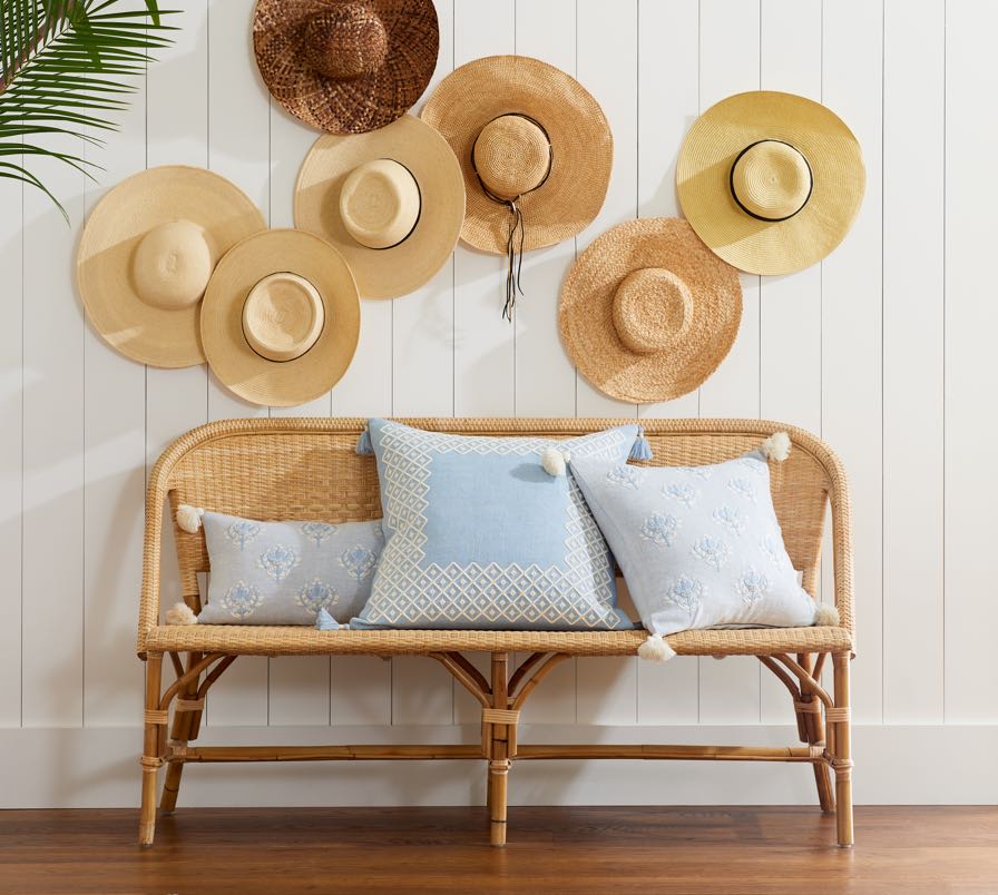 Serena & Lily bench with straw hats as gallery wall