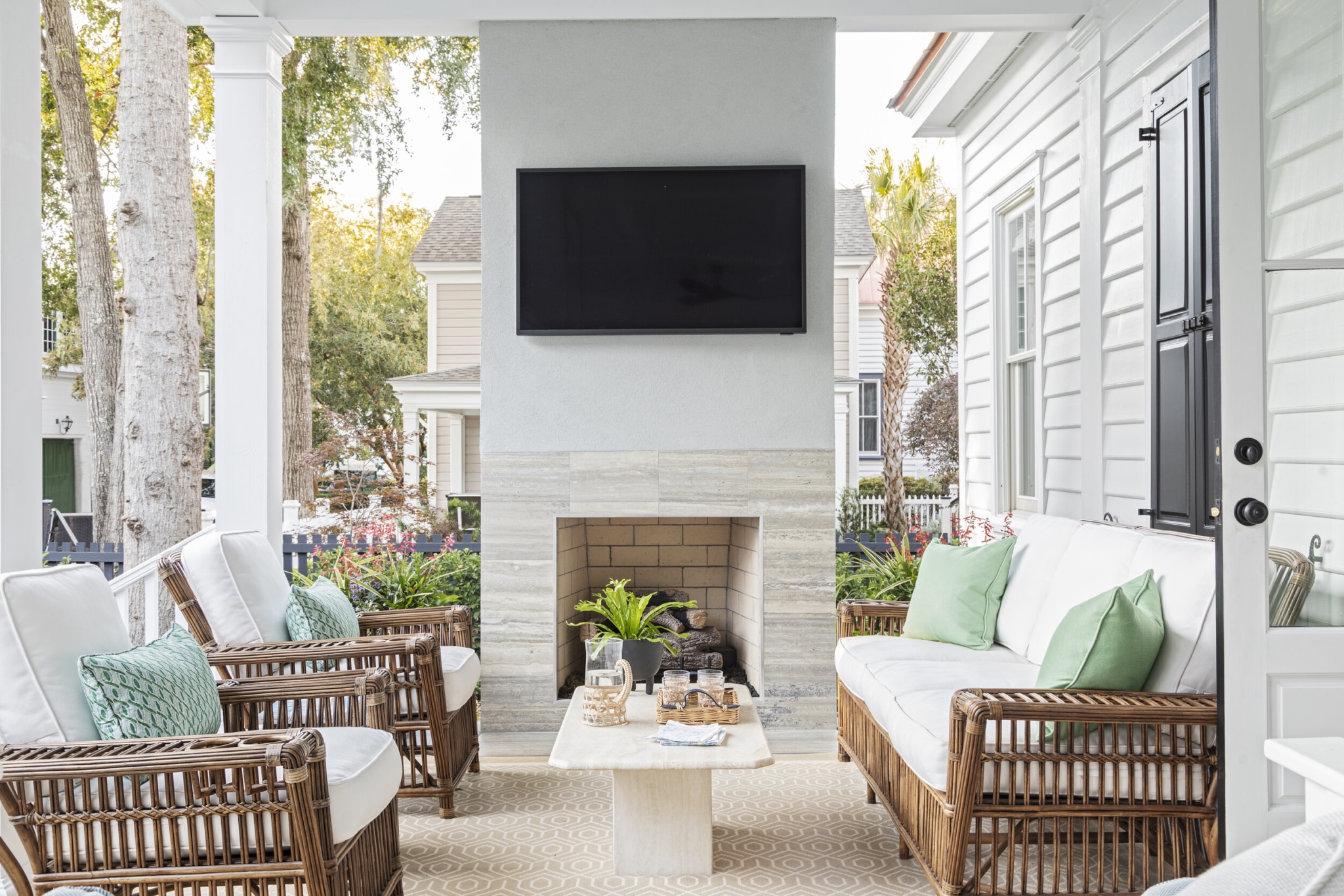 Allison Elebash Design | Julia Lynn Photography Mount Pleasant home - covered porch with outdoor television - wicker - outdoor fireplace
