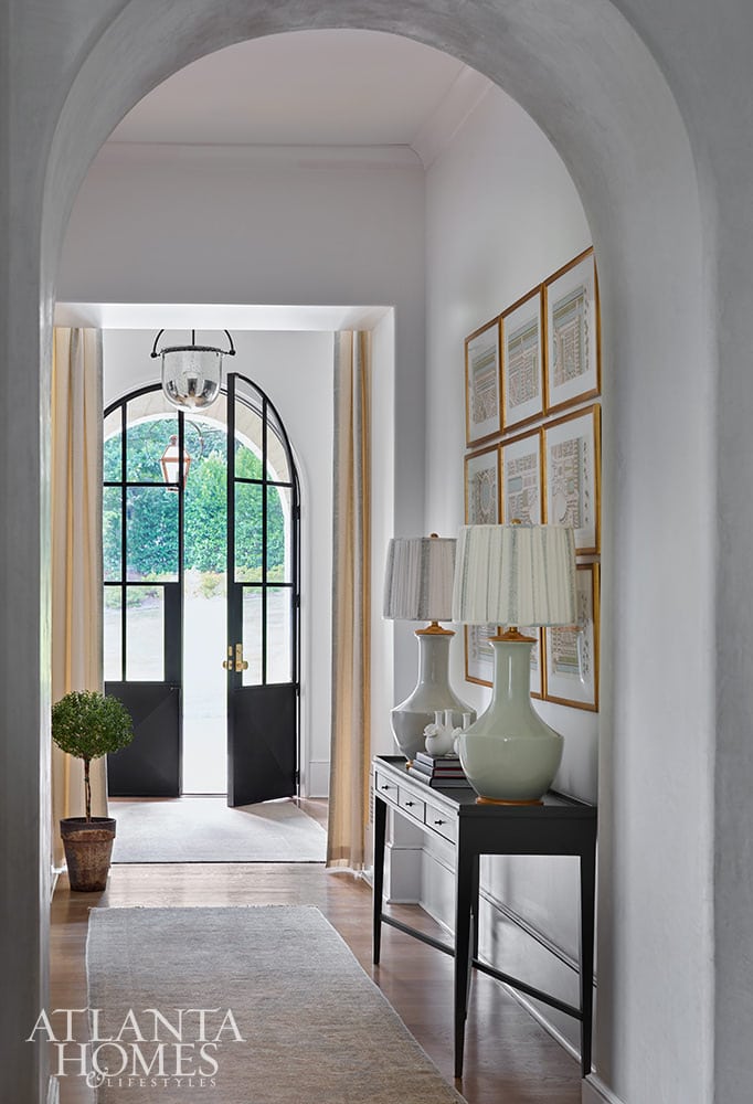 Southern charm house tour designed by T.S. Adams Studio, with interiors by Lauren DeLoach and photographed by the amazing Emily Followill - welcome - entry - foyer - steel doors - gallery wall