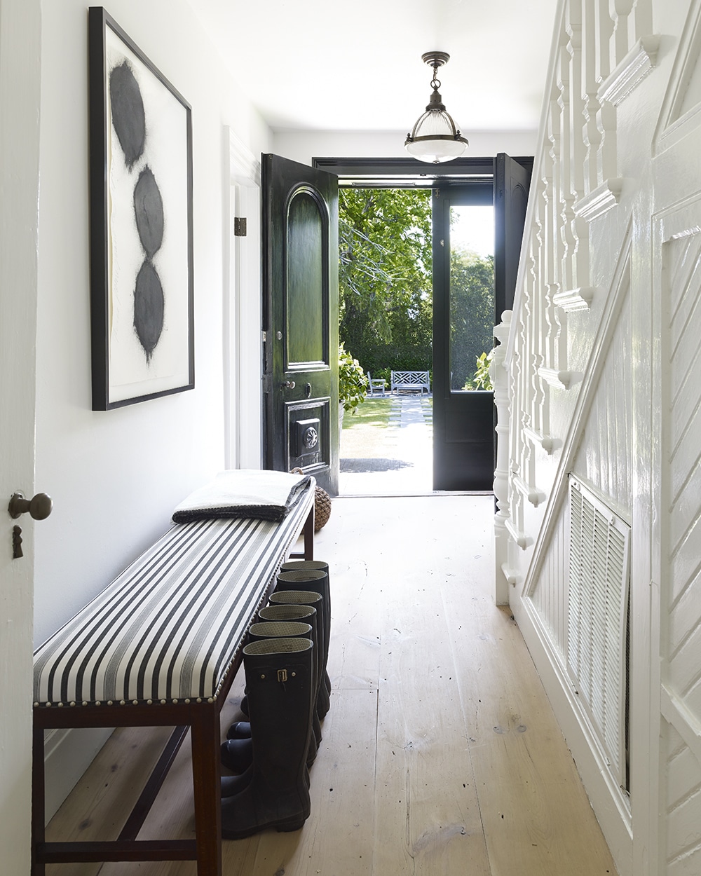 Mark Cunningham designed Southampton home - entry, foyer, black and white, black and white art, abstract art, bench, foyer bench, black front doors