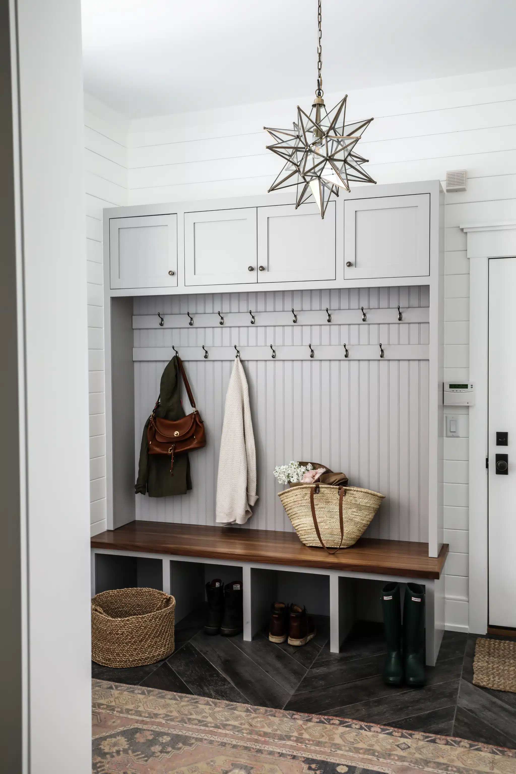A mudroom entry, is a transitional space found in many homes, especially in regions with varying weather conditions. It serves as a buffer zone between the outdoors and the interior of the house and when it comes to creating well-thought-out mudroom designs, Park and Oak Interior Design truly stands out.