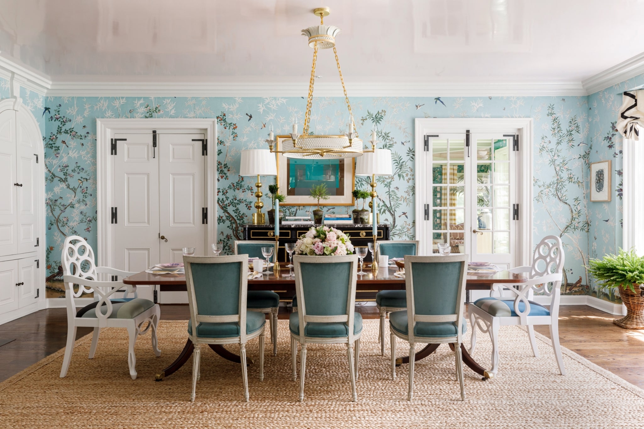 Paloma Contreras, celebrated interior designer and tastemaker, has once again captivated design enthusiasts with her latest book, The New Classic Home: Where Timeless Style Meets Modern Design. Aimée Mazzenga Photography - oval dining room table with chairs - deGournay wallpaper