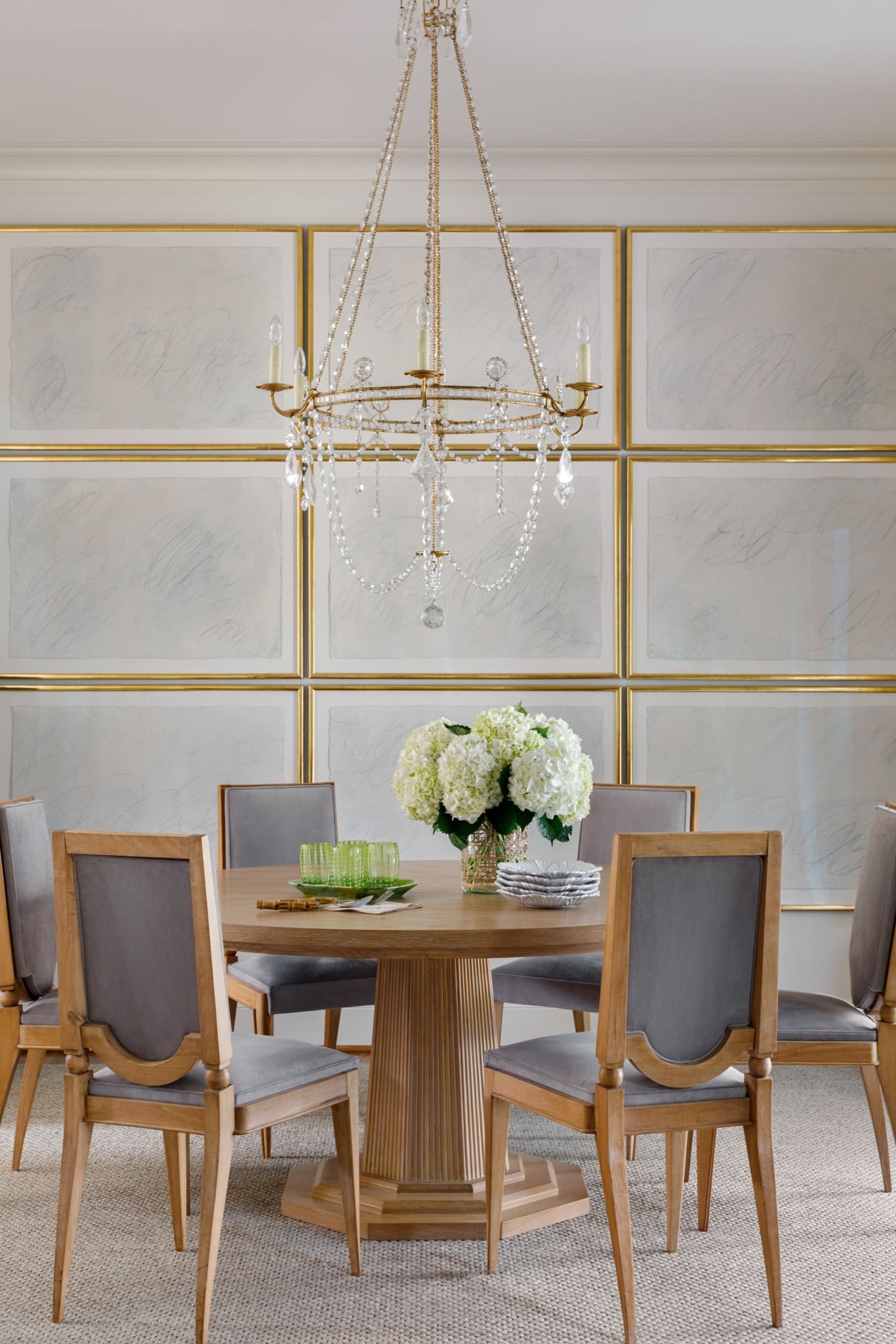 Paloma Contreras, celebrated interior designer and tastemaker, has once again captivated design enthusiasts with her latest book, The New Classic Home: Where Timeless Style Meets Modern Design. Aimée Mazzenga Photography = gallery wall - round dining table - crystal chandelier