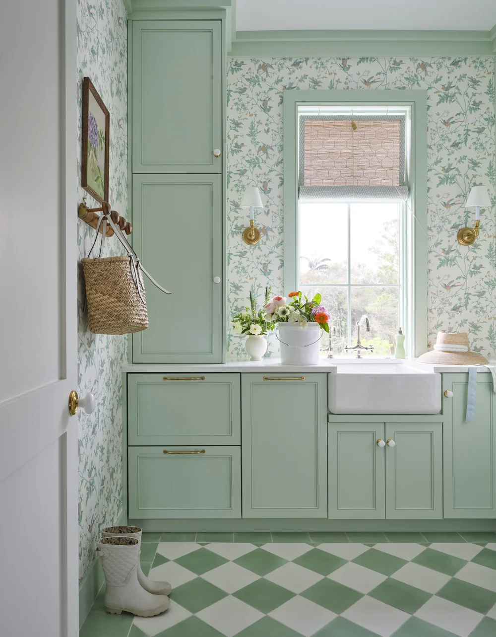 You know how much we love the designs of Kara Miller. It’s a wonderful getaway — even if the getaway is only on your monitor! Brantley Photography - green laundry room with green and white wallpaper and white farmhouse sink