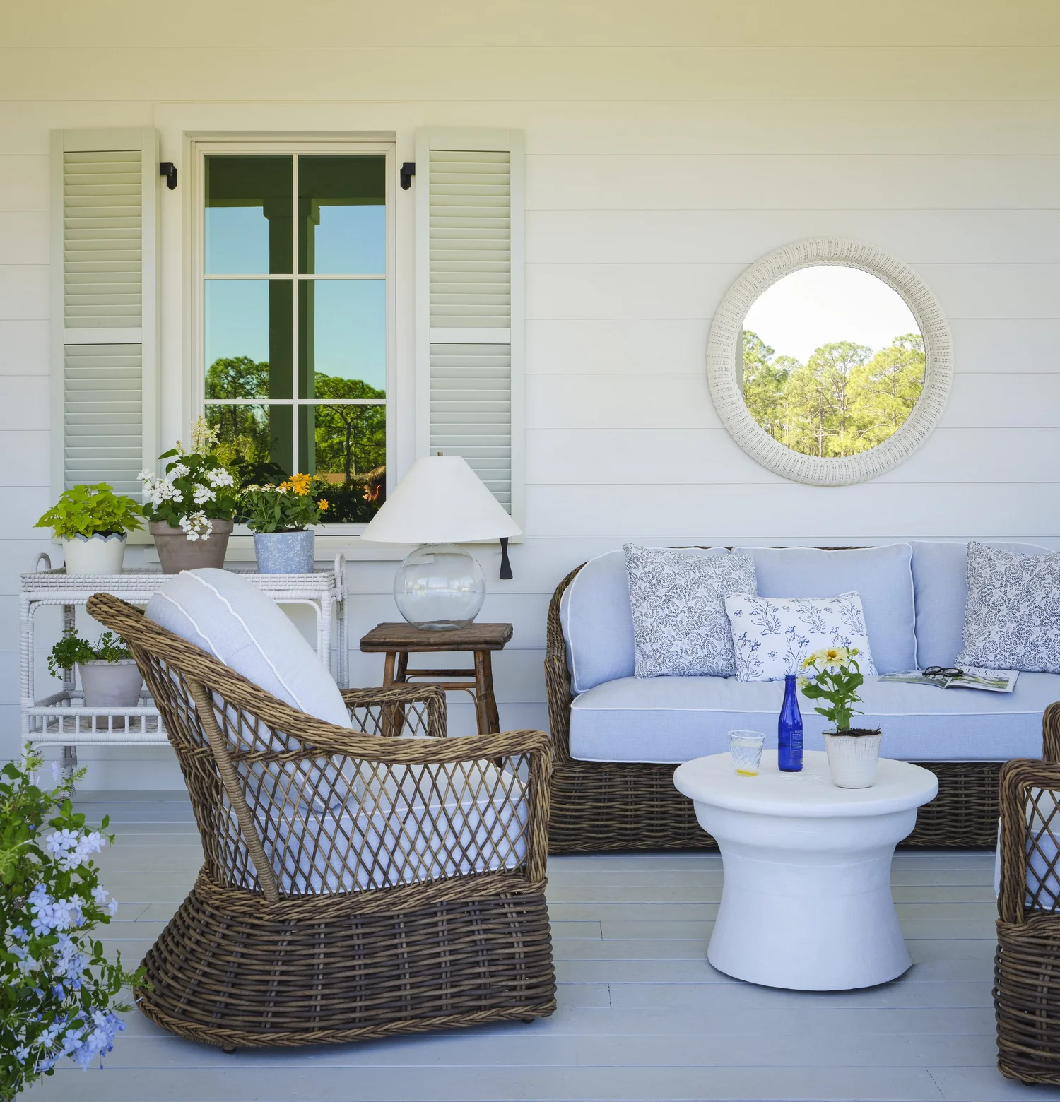 You know how much we love the designs of Kara Miller. Her new home is a wonderful getaway — even if the getaway is only on your monitor! Brantley Photography porch with wicker furniture