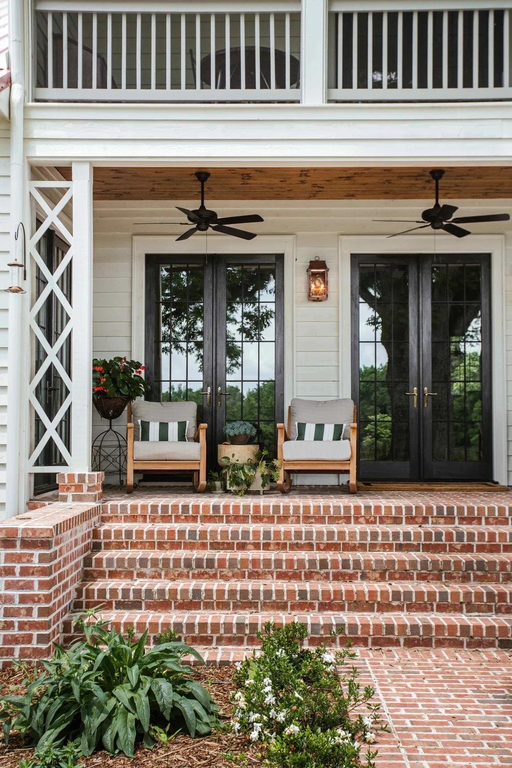 Perfectly proportioned, wholly welcoming and full of Southern charm, this farmhouse designed by The Misfit House and photographed by the amazing Kristin Karch Photography  is totally making our day.  Take a peek, and we think you’ll understand why! Love the covered porch with ceiing fans