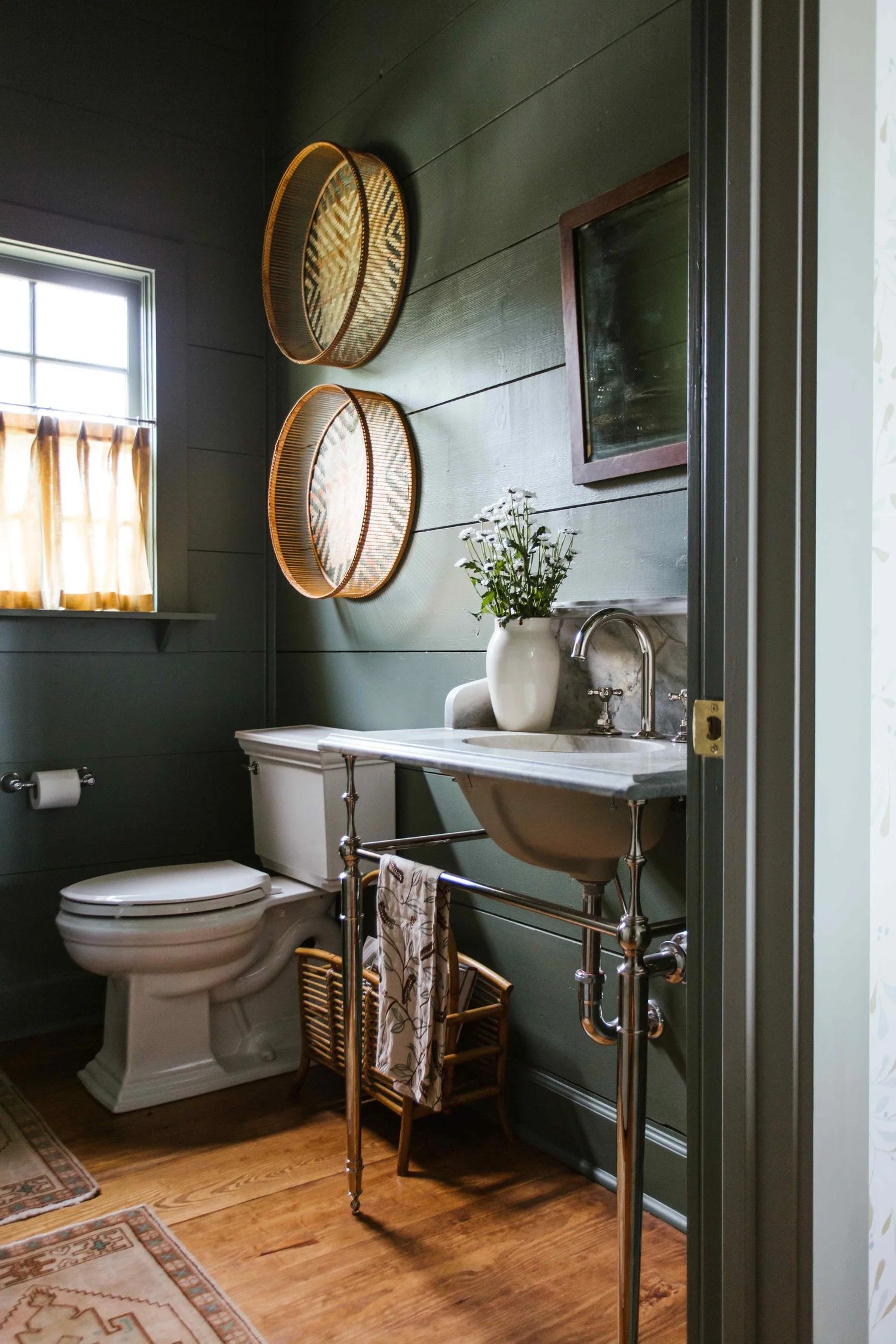 Perfectly proportioned, wholly welcoming and full of Southern charm, this farmhouse designed by The Misfit House and photographed by the amazing Kristin Karch Photography  is totally making our day.  Take a peek, and we think you’ll understand why! Love the four chair seating area in the living room with the shiplap ceiling - kitchen with bionde wood cabinets and brass hardware