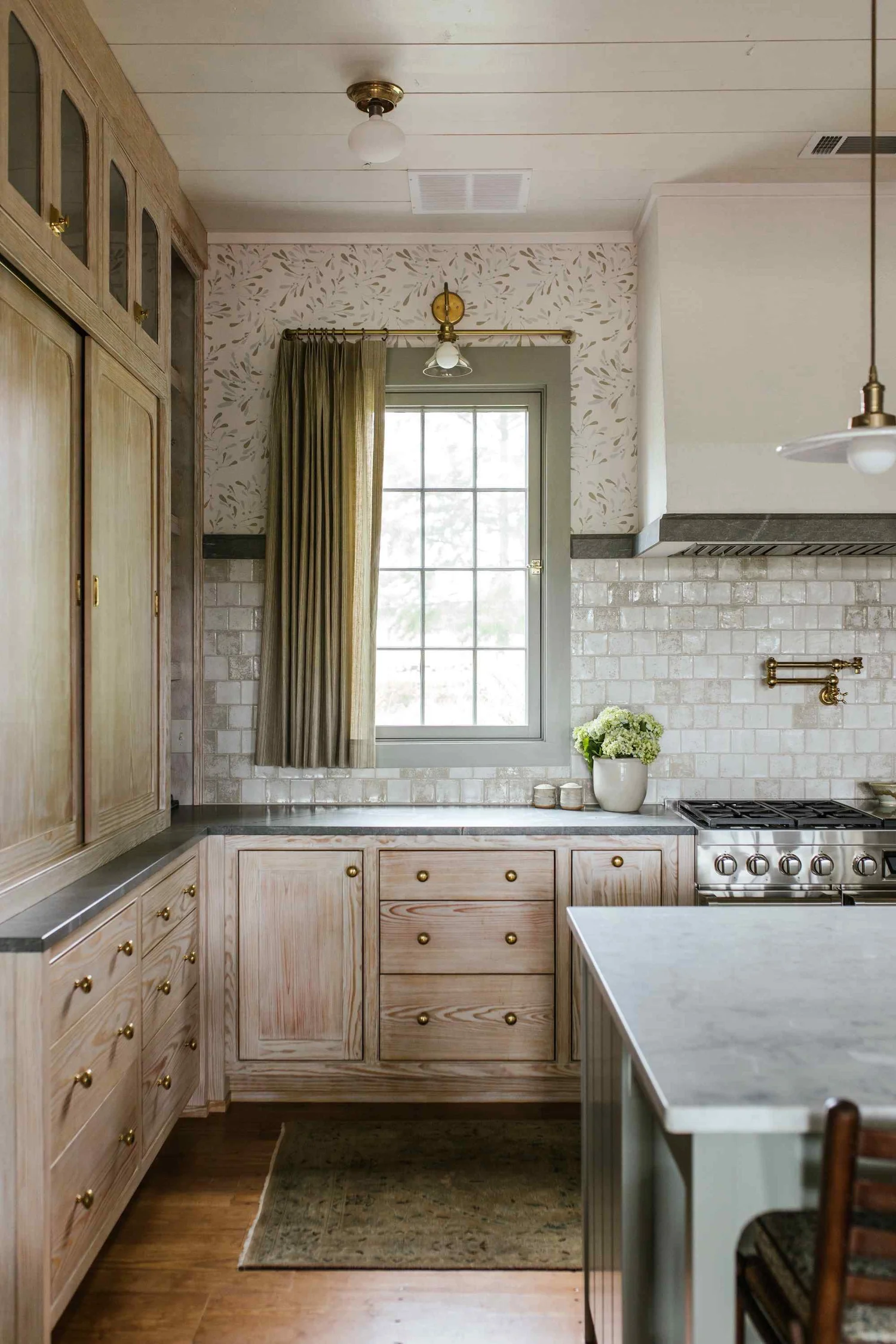Perfectly proportioned, wholly welcoming and full of Southern charm, this farmhouse designed, by The Misfit House and photographed by the amazing Kristin Karch Photography  is totally making our day.  Take a peek, and we think you’ll understand why! Love the four chair seating area in the living room with the shiplap ceiling - kitchen with bionde wood cabinets and brass hardware