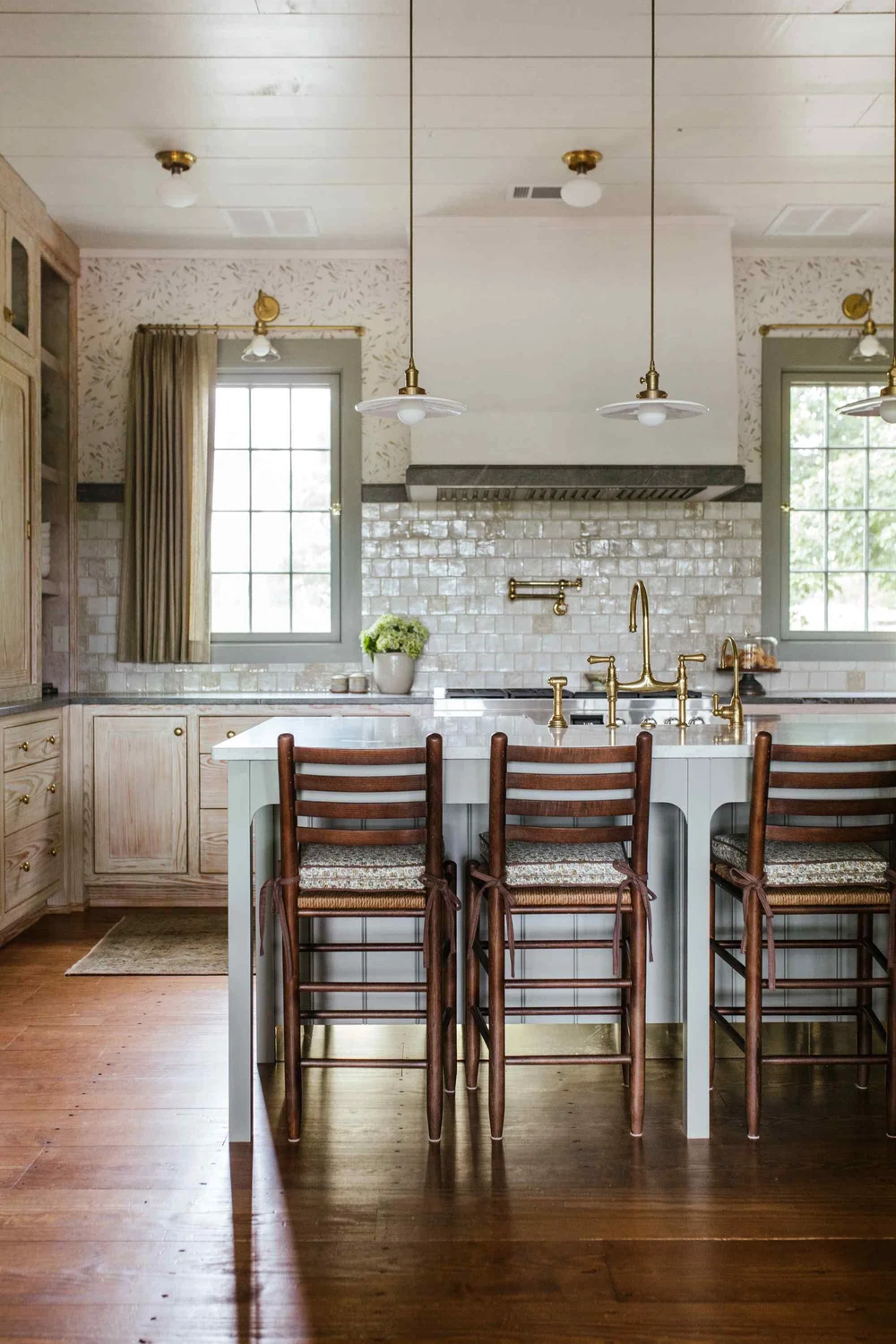 Perfectly proportioned, wholly welcoming and full of Southern charm, this farmhouse designed by The Misfit House and photographed by the amazing Kristin Karch Photography  is totally making our day.  Take a peek, and we think you’ll understand why! Love the four chair seating area in the living room with the shiplap ceiling - kitchen with blonde wood cabinets and brass hardware