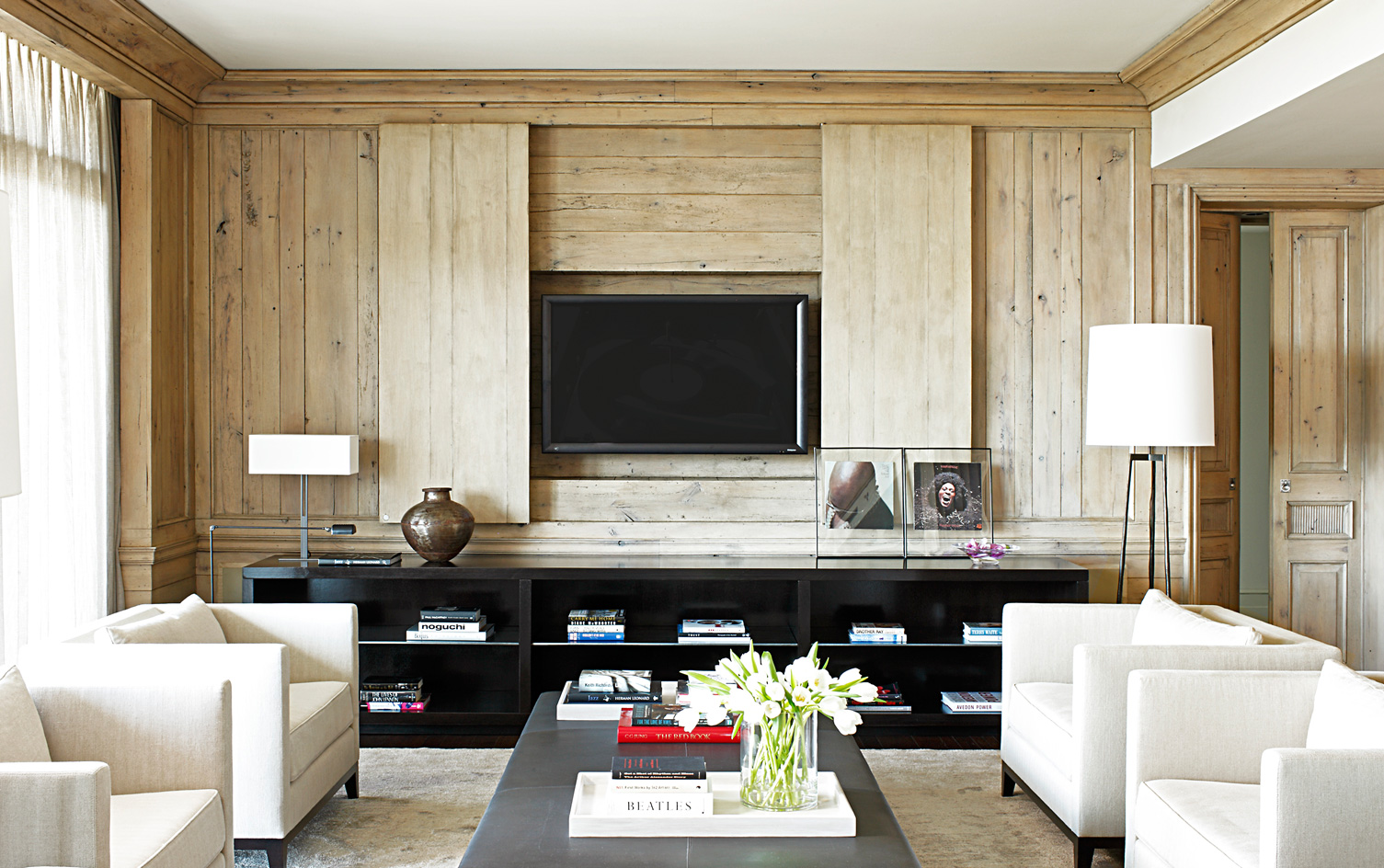Beautiful home architecture is the foundation of everything in a home, and the details are key. Paul Bates Architecture | Betsy Brown Interiors - living room with neutral decor and blonde wood paneling