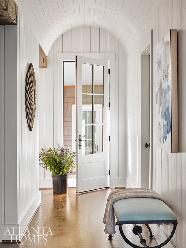 Lake Martin lake house designed by Liz Williams entry with shiplap If you're looking for the perfect oasis, look no further than this  gorgeous lake house, with beautiful interior design ideas, on Alabama's Lake Martin designed by the talented Liz Williams. PHOTOGRAPHER: Emily Followill INTERIOR DESIGN: Liz Williams Interiors lizwilliamsinteriors.com ARCHITECT:  Mitch Ginn, L. Mitchell Ginn & Associates LANDSCAPE ARCHITECT:  Outside Landscape Group