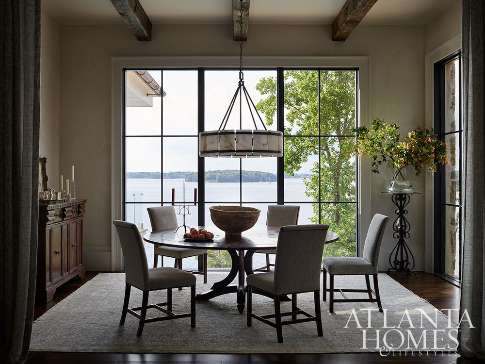 As summer comes to an end, we hope you can steal away for a moment to take a peek at this gorgeous Lake Norman home so beautifully photographed by Emily Followill and chicly styled by Eleanor Roper.  It’s a peaceful, calming home–with incredible views–that just might lend you a moment of serenity as you savor these stunning interiors.  Jacquelynne P. Lanham Designs created a space that truly feels like a zen retreat, the perfect place to start a stress-free fall! Dining room with round table and gorgeous lake views Source: Atlanta Homes & Lifestyles Interior Designer: Jackye Lanham, Jacquelynne P. Lanham Designs  Architect: John D. Haley, John D. Haley  Builder: Scott McMillan, Kingswood Custom Homes, Inc. Landscape Architect: John Howard, Howard Design Studio