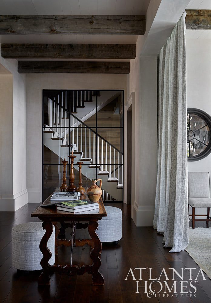 As summer comes to an end, we hope you can steal away for a moment to take a peek at this gorgeous Lake Norman home so beautifully photographed by Emily Followill and chicly styled by Eleanor Roper.  It’s a peaceful, calming home–with incredible views–that just might lend you a moment of serenity as you savor these stunning interiors.  Jacquelynne P. Lanham Designs created a space that truly feels like a zen retreat, the perfect place to start a stress-free fall! Entrance foyer in a Lake Norman home Source: Atlanta Homes & Lifestyles Interior Designer: Jackye Lanham, Jacquelynne P. Lanham Designs  Architect: John D. Haley, John D. Haley  Builder: Scott McMillan, Kingswood Custom Homes, Inc. Landscape Architect: John Howard, Howard Design Studio