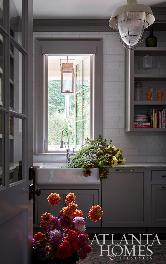 As summer comes to an end, we hope you can steal away for a moment to take a peek at this gorgeous Lake Norman home so beautifully photographed by Emily Followill and chicly styled by Eleanor Roper.  It’s a peaceful, calming home–with incredible views–that just might lend you a moment of serenity Jacquelynne P. Lanham Designs created a space that truly feels like a zen retreat, the perfect place to start a stress-free fall! Gray kitchen with white subway tile backsplash and farmhouse sink Source: Atlanta Homes & Lifestyles Interior Designer: Jackye Lanham, Jacquelynne P. Lanham Designs  Architect: John D. Haley, John D. Haley  Builder: Scott McMillan, Kingswood Custom Homes, Inc. Landscape Architect: John Howard, Howard Design Studio