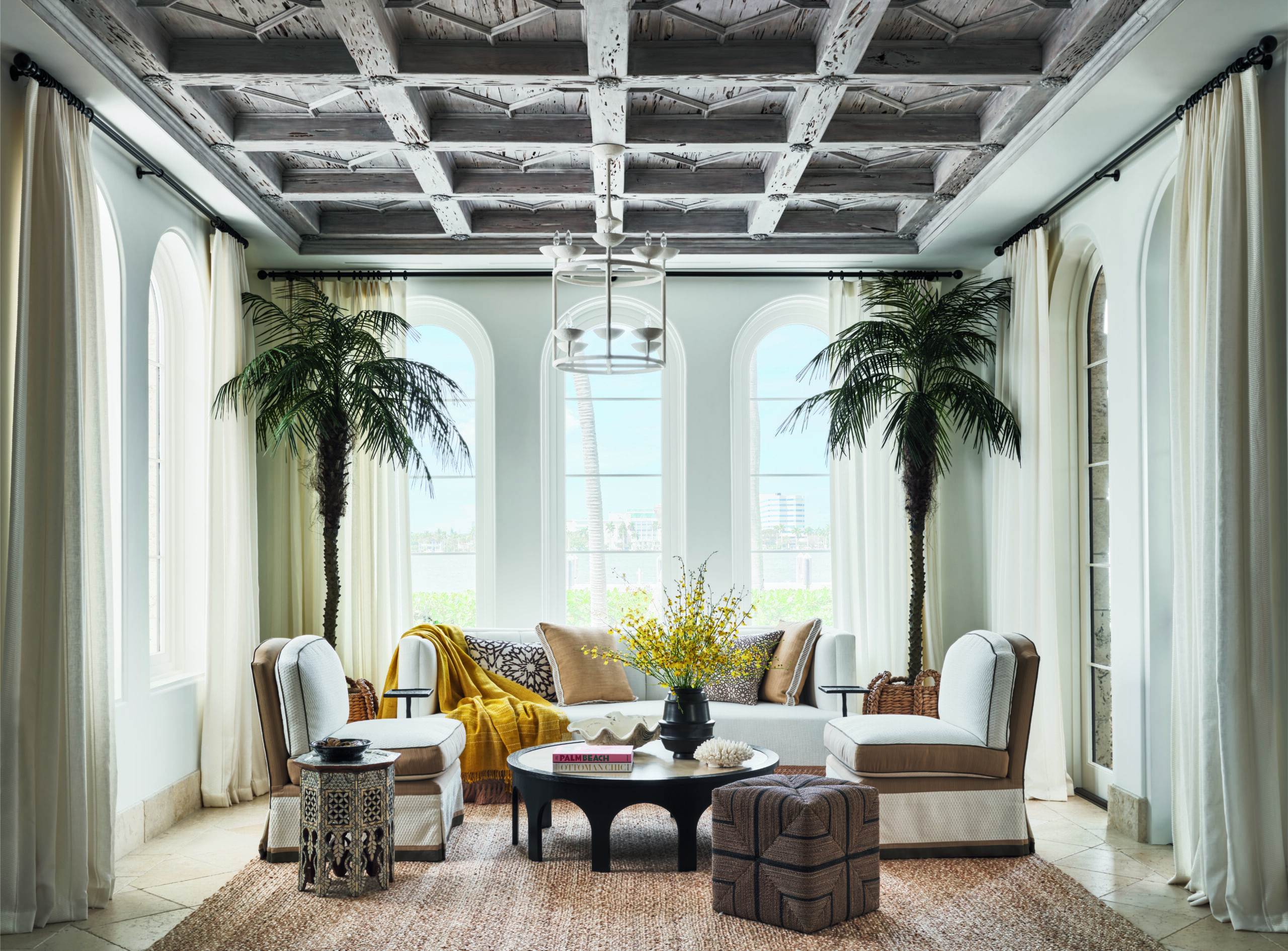 There are few things we look forward to more than sharing a sneak peek of a new coffee table book! If you are looking for chic, sophisticated and gorgeous living, don't miss the latest addition to our collection,  Hilfiger Homes.  Coastal living room with Palm trees in the corner 