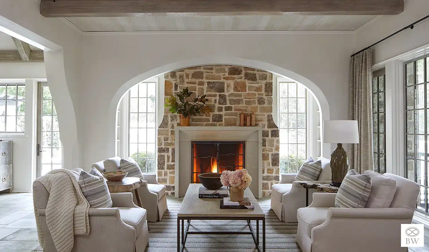 Beth Webb, one of our favorite designers and most frequented credits on Design Chic, is celebrated for her exceptional talent in interior design. Webb seamlessly blends timeless elegance with contemporary functionality, and these stunning living rooms are no exception. Jean Allsopp Photography - neutral living room with stone fireplace