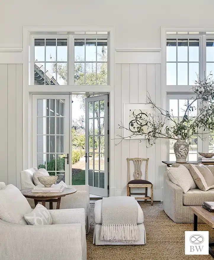 Beth Webb, one of our favorite designers and most frequented credits on Design Chic, is celebrated for her exceptional talent in interior design. Webb seamlessly blends timeless elegance with contemporary functionality, and these stunning living rooms are no exception. Emily Followill Photography - living room with large windows and double french doors and neutral decor