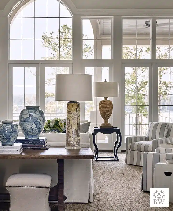 Beth Webb, one of our favorite designers and most frequented credits on Design Chic, is celebrated for her exceptional talent in interior design. Webb seamlessly blends timeless elegance with contemporary functionality, and these stunning living rooms are no exception. Emily Followill Photography - living room with large windows and blue and white decor