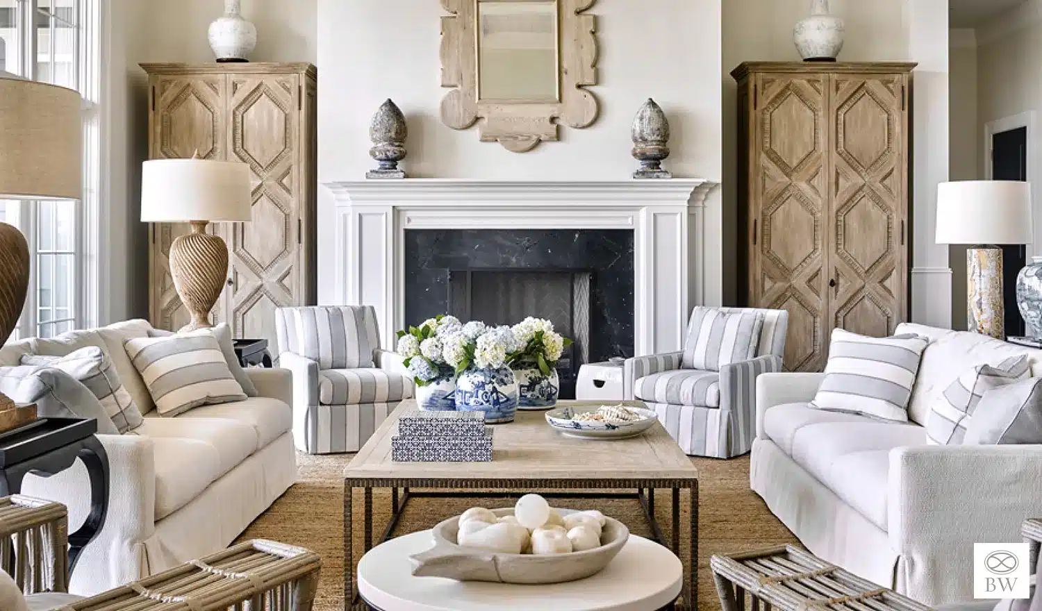 Beth Webb, one of our favorite designers and most frequented credits on Design Chic, is celebrated for her exceptional talent in interior design. Webb seamlessly blends timeless elegance with contemporary functionality, and these stunning living rooms are no exception. Emily Followill Photography - living room with striped chairs and symmetrical design