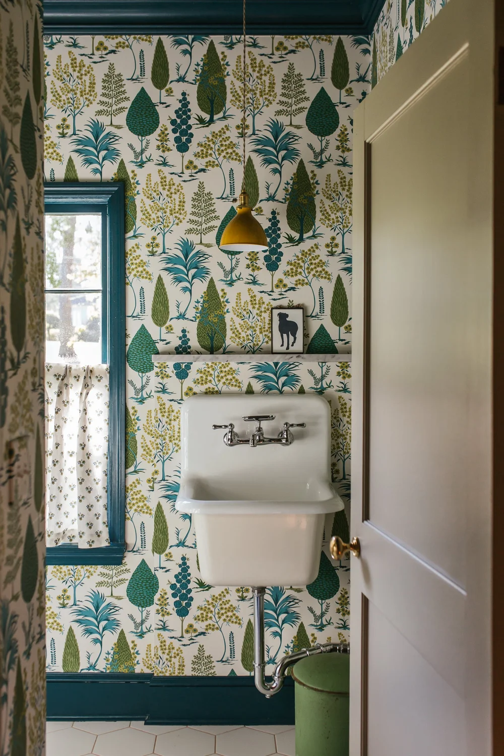 Classic interiors balance comfort with elegance, familiar with fresh, and functionality with beauty. Small touch a fabulous brass range hood, a stack of antique books or a personal collection that is uniquely yours can have a big impact.  This beautiful home designed by The Misfit House and photographed by Kristin Karch Photography - powder room with great wallpaper