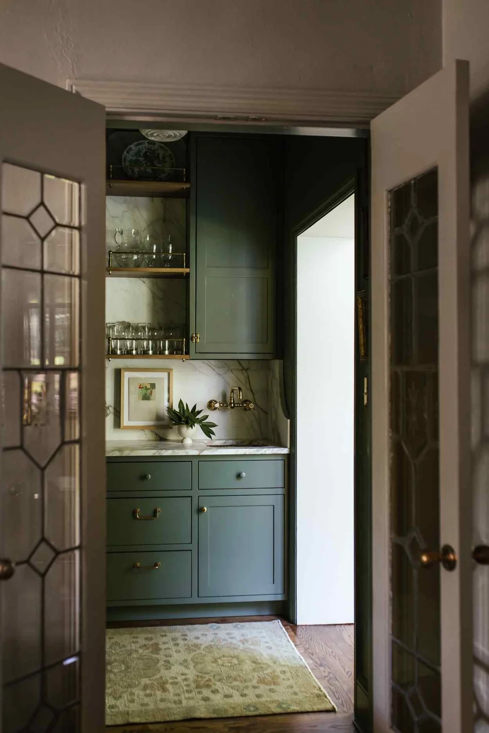  Small touch a fabulous brass range hood, a stack of antique books or a personal collection that is uniquely yours can have a big impact.  This beautiful home designed by The Misfit House and photographed by Kristin Karch Photography - love the butler's pantry and bar