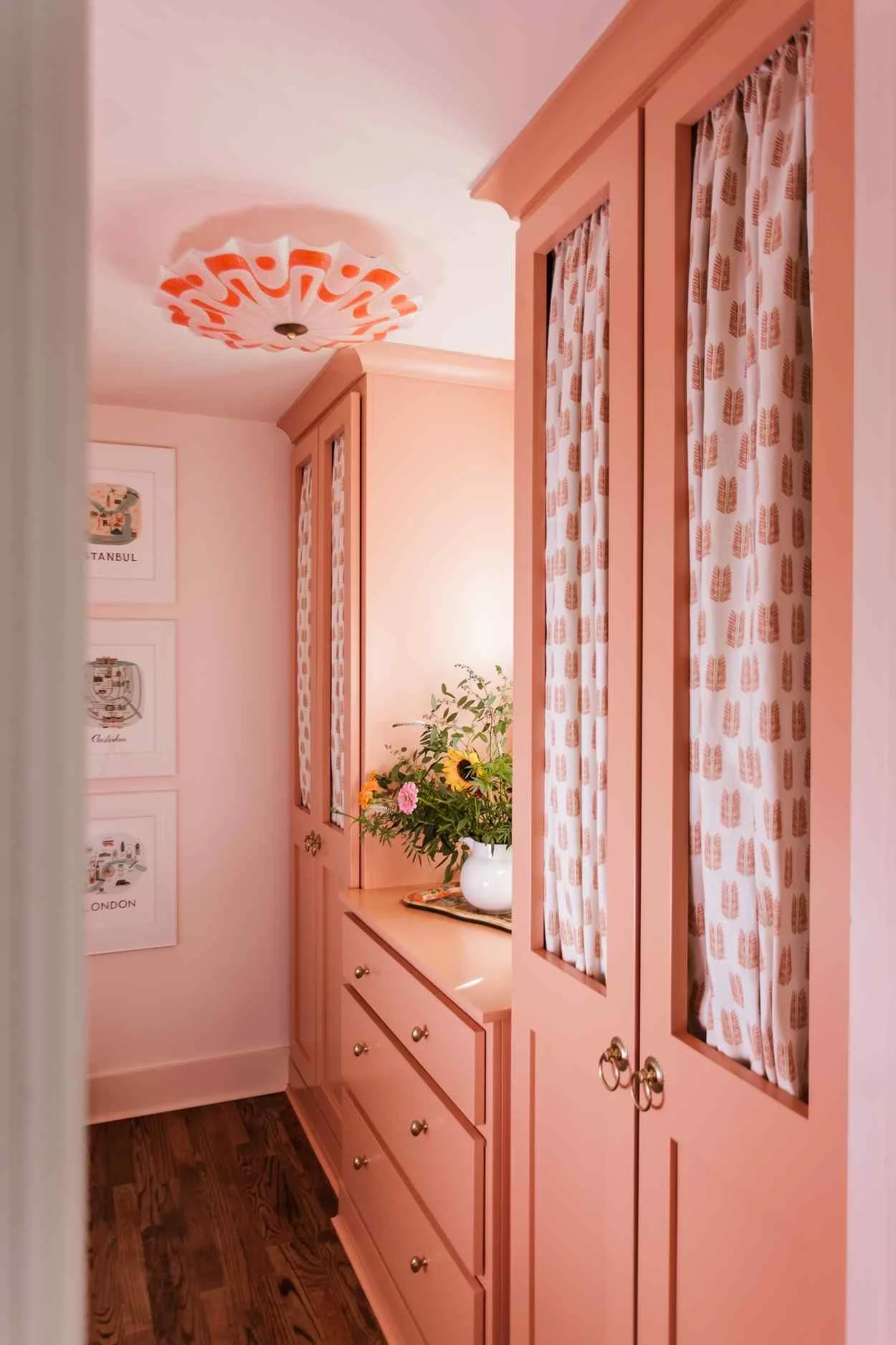 Classic interiors balance comfort with elegance, familiar with fresh, and functionality with beauty. Small touch a fabulous brass range hood, a stack of antique books or a personal collection that is uniquely yours can have a big impact.  This beautiful home designed by The Misfit House and photographed by Kristin Karch Photography - pink laundry room