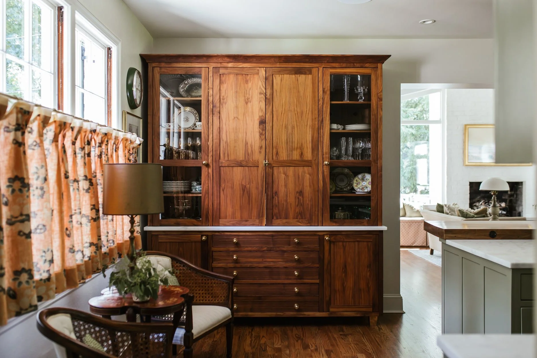 Classic interiors balance comfort with elegance, familiar with fresh, and functionality with beauty. Small touch a fabulous brass range hood, a stack of antique books or a personal collection that is uniquely yours can have a big impact.  This beautiful home designed by The Misfit House and photographed by Kristin Karch Photography