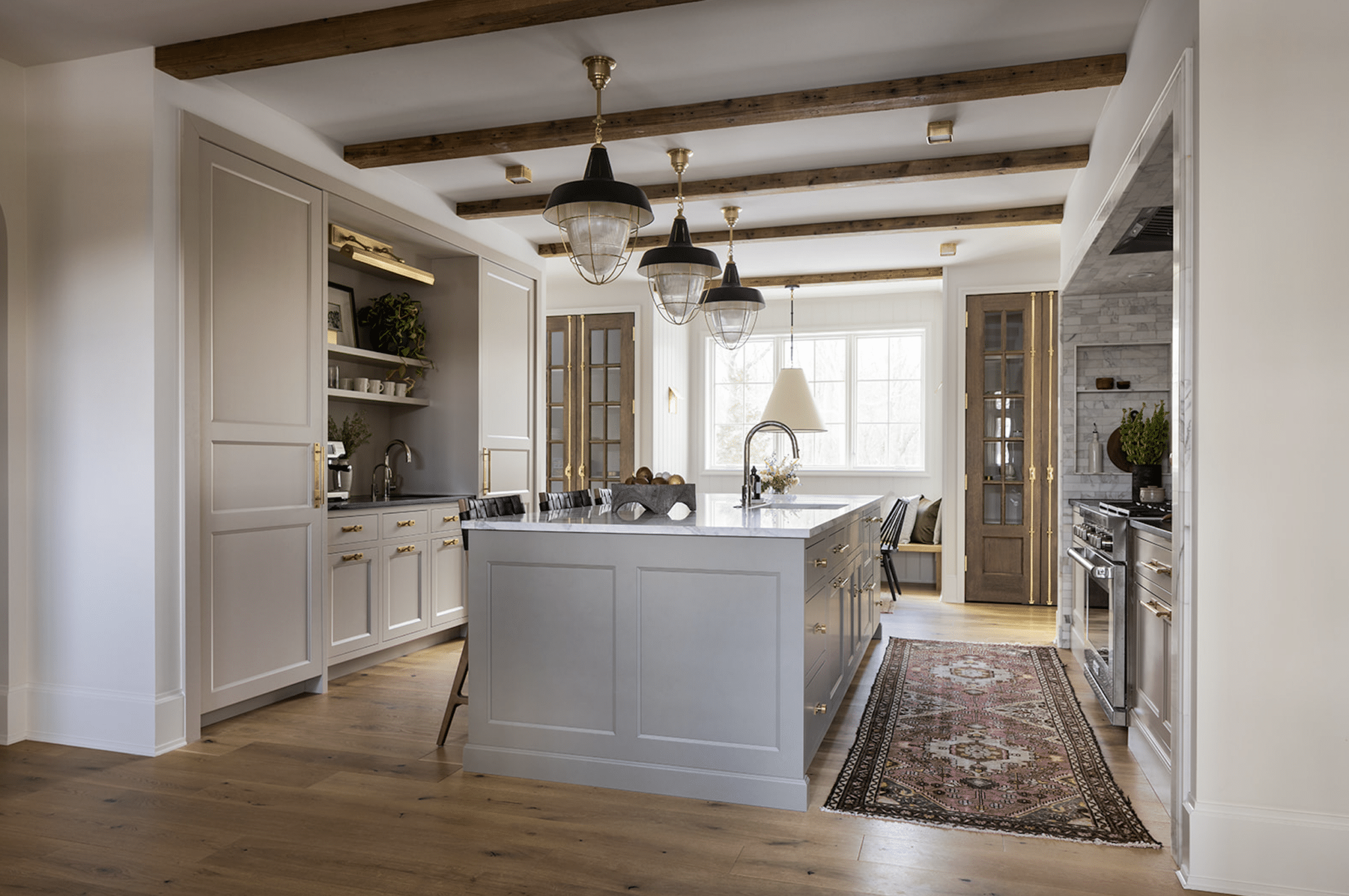 Designing a small coffee bar within your kitchen can add both functionality and charm to your space. Jean Stoffer Design | Stoffer Photography Interiors