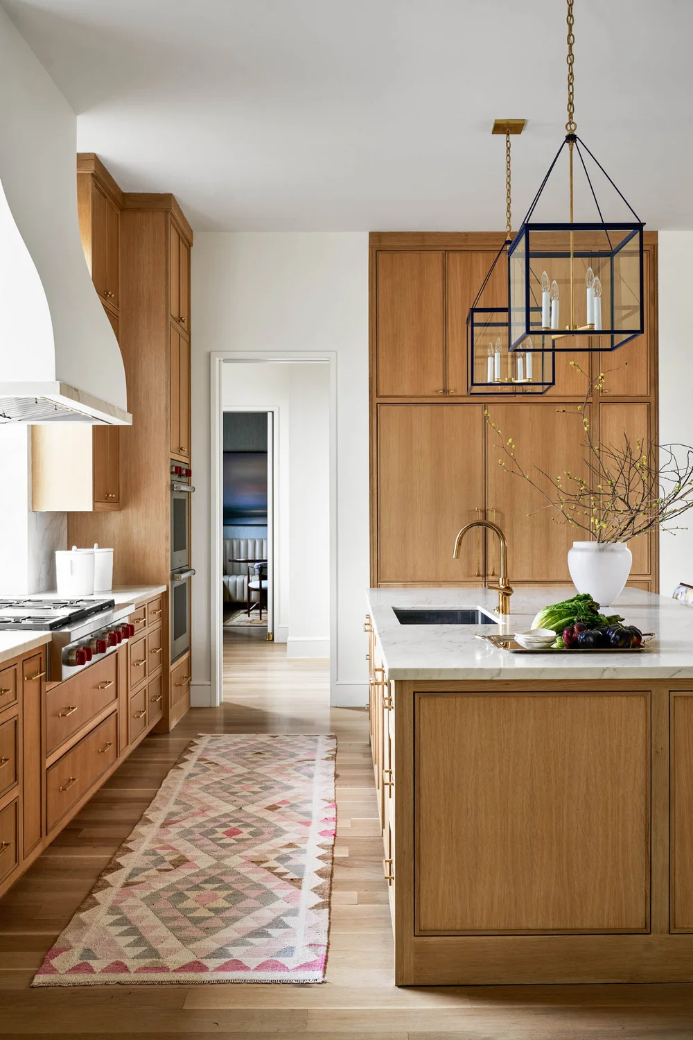 This kitchen is proof that stained kitchens can feel warm and modern without a rustic element in site. The clean cabinetry and beautiful white stone blend to create a completely inviting and livable room. Nathan Schroder Photography