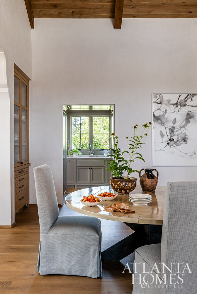 Favorite designers, Beth Webb  in collaboration with architect Heyward Russell Studio, inspire us at every turn - dining room with a round table -Situated on 800 acres, this warm and welcoming family home is built with intention - not just for beauty but for living.