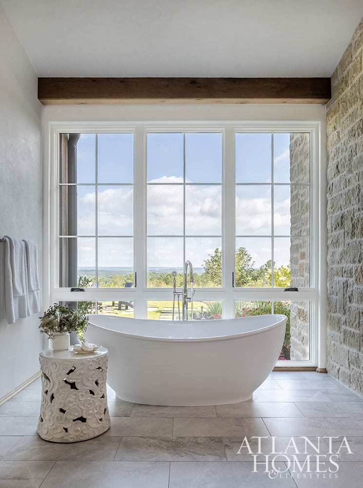 Favorite designers, Beth Webb  in collaboration with architect Heyward Russell Studio, inspire us at every turn - serene bathroom with stone walls and freestanding tub overlooking land