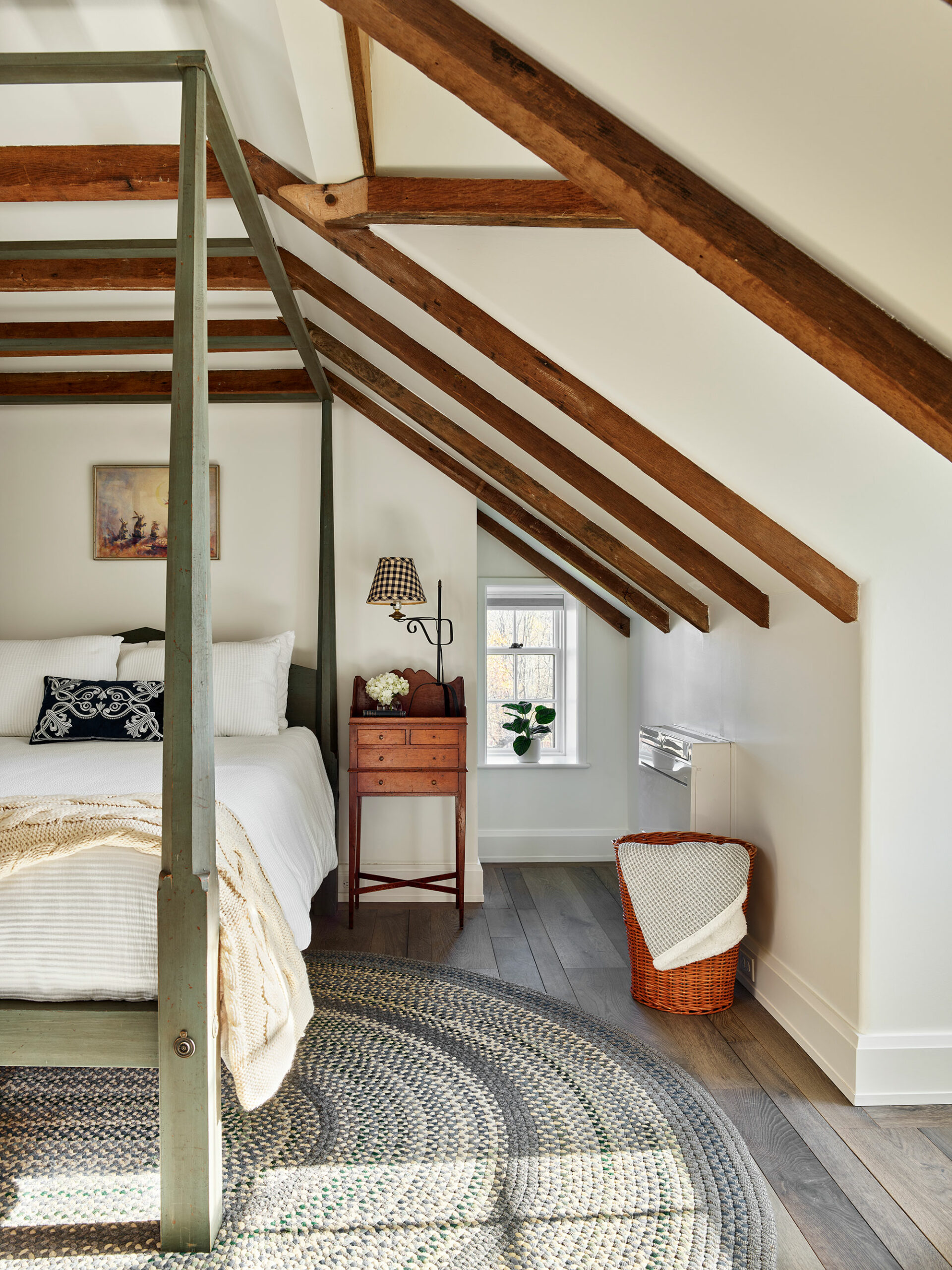 As the holidays come to an end, we hope you can steal away for a moment to take a peek at this gorgeous Archer & Buchanan Architecture designed home, photographed by Jeffrey Totaro and built by Griffiths Construction, Inc. This thoughtful restoration created a peaceful, calming home–with incredible views–that just might lend you a moment of serenity as you savor these beautiful interior design ideas. Archer & Buchanan created a space that truly feels like a zen retreat, the perfect place to start a stress-free new year! Their designs are grounded in the past, designed for the present, and intended to be gorgeous and functional for family and friends to enjoy for years to come. Beautiful bedroom with 4 poster bed and wood beams