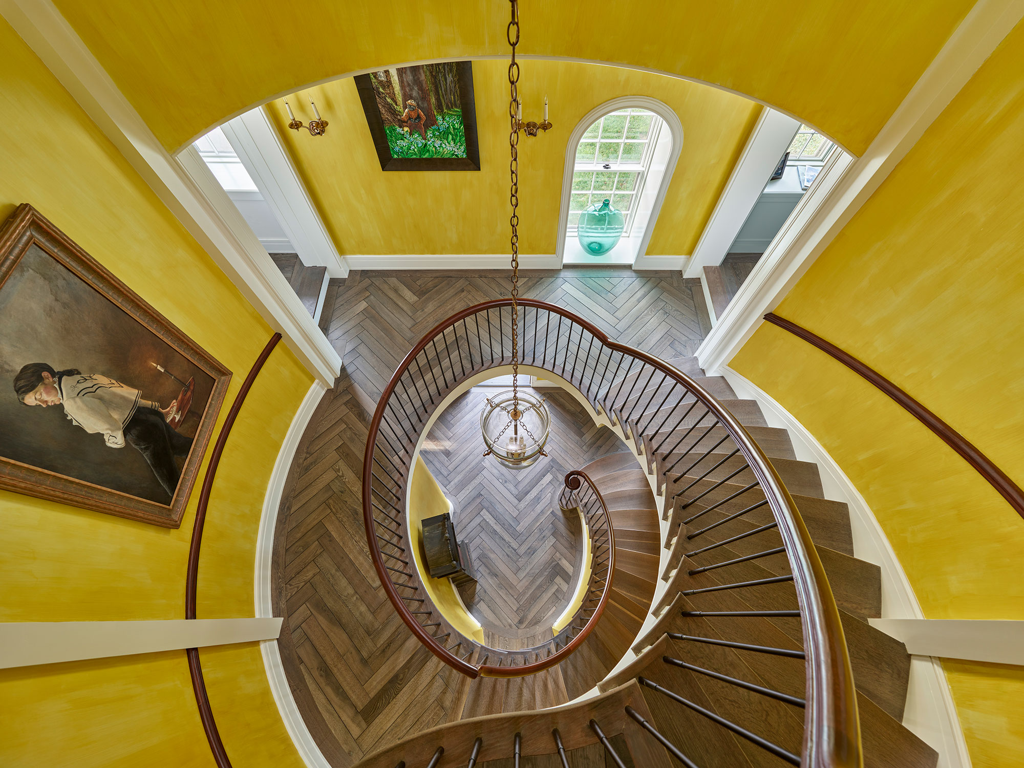 As the holidays come to an end, we hope you can steal away for a moment to take a peek at this gorgeous Archer & Buchanan Architecture designed home, photographed by Jeffrey Totaro and built by Griffiths Construction, Inc. This thoughtful restoration created a peaceful, calming home–with incredible views–that just might lend you a moment of serenity as you savor these beautiful interior design ideas. Archer & Buchanan created a space that truly feels like a zen retreat, the perfect place to start a stress-free new year! Their designs are grounded in the past, designed for the present, and intended to be gorgeous and functional for family and friends to enjoy for years to come. Circular staircase