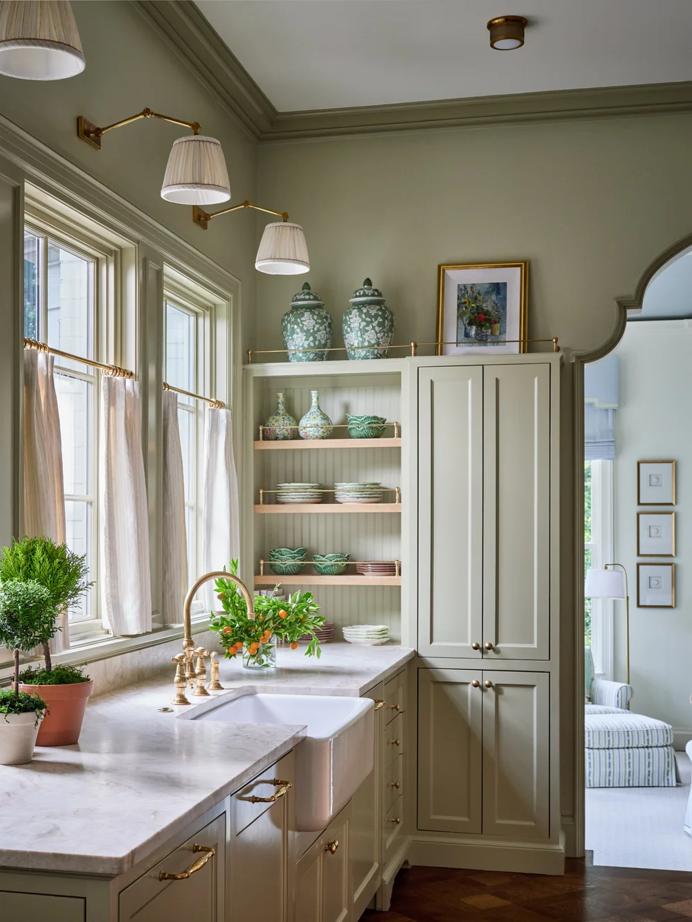 Take a look at 9 beautiful kitchens designed by Jenkins Interiors, each with its unique interpretation of warmth, functionality, and enduring style. Nathan Schroder PHotography - green paint with brass hardware