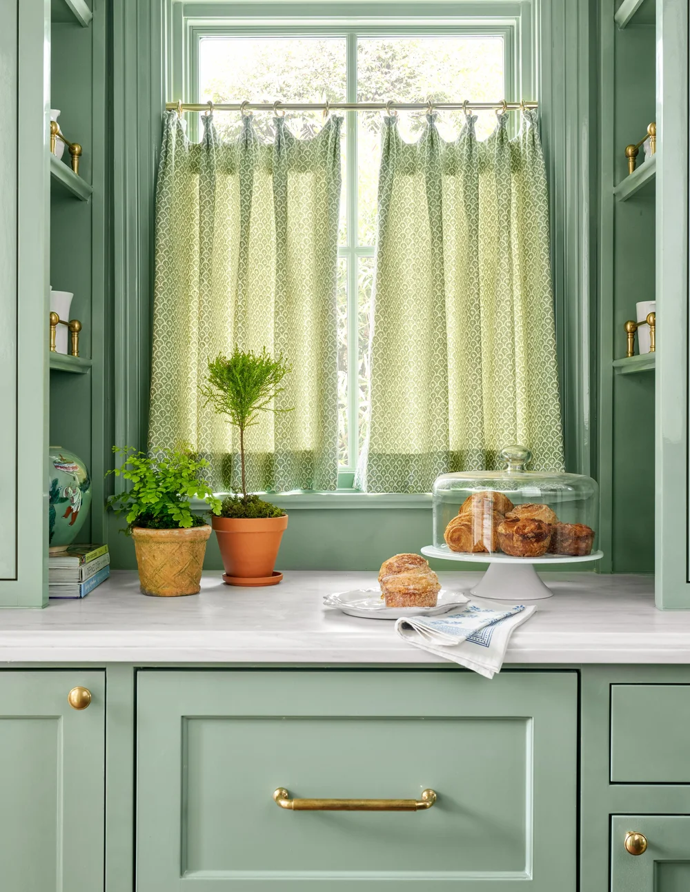 Take a look at 9 beautiful kitchens designed by Jenkins Interiors, each with its unique interpretation of warmth, functionality, and enduring style. Nathan Schroder PHotography - green paint with white marble countertops