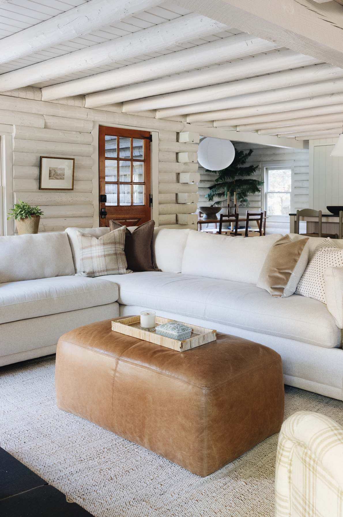 Jean Stoffer Interior Design | Stoffer Photography Interior - love the log cabin painted white inside with white sectional sofa and leather ottoman