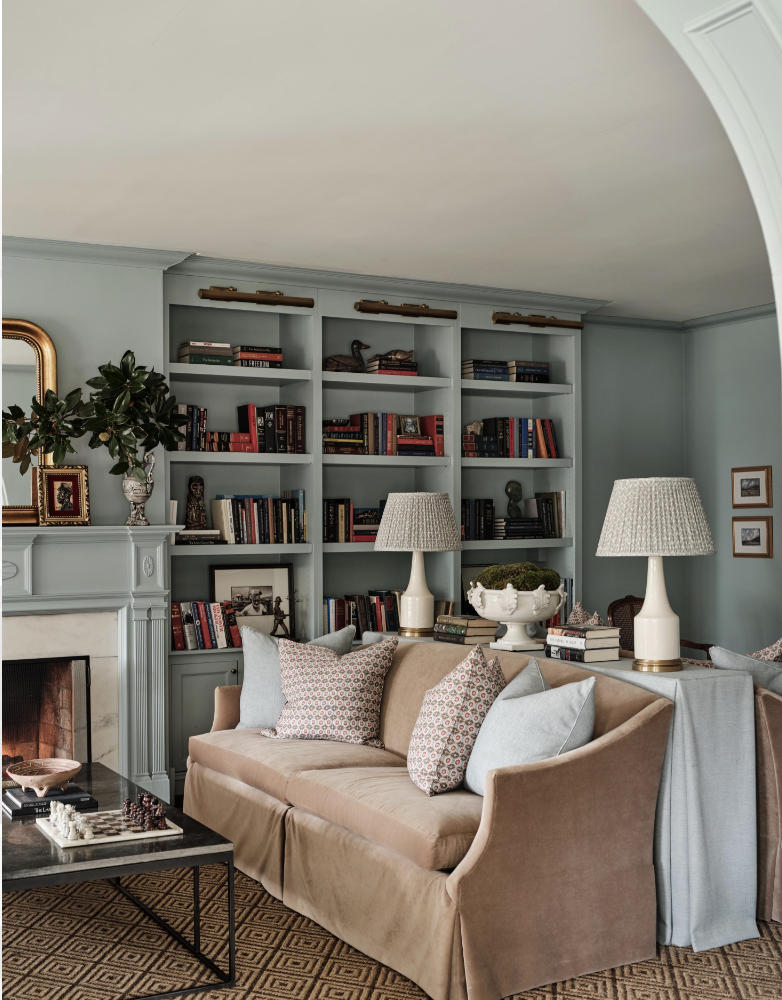 There was a time when open floor plans felt like the ultimate luxury. But lately, we have noticed a shift to rooms with a purpose. Love a library with Visual Comfort brass library lights and beautiful moody blue walls - Sabbe Interior design | Joseph Bradshaw Photography