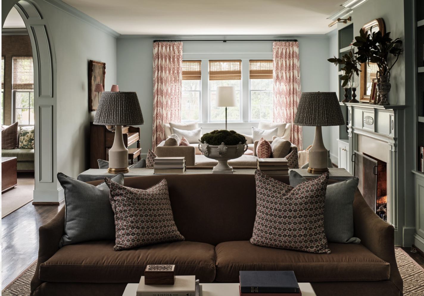 There was a time when open floor plans felt like the ultimate luxury. But lately, we have noticed a shift to rooms with a purpose. Love a library with Visual Comfort brass library lights and beautiful moody blue walls - Sabbe Interior design | Joseph Bradshaw Photography